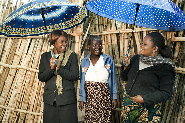  Rose, center, stands with two of the peer mothers who helped her through the challenges of getting on antiretroviral treatment and working to keep her baby HIV-free. Photo by Sydelle Willow Smith
