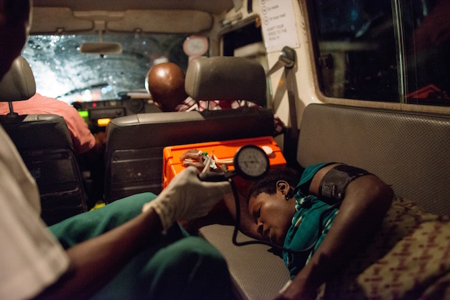 A pregnant woman is transported in an MSF ambulance from a government health clinic to the GRC. She is not yet in labor, but is at high risk for needing a C-section when it is time to deliver. She will stay in an MSF maternal waiting house, where expectant mothers can live beside the GRC, under the observation of medical staff, until delivery. Photo by Lynsey Addario/VII