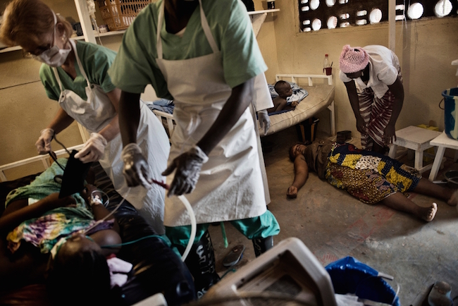 Dr. Raney and another medical staff member try to save a 20-year-old woman who went into a coma after suffering from post-partum hemorrhage at a government clinic. The patients was driven two hours to the Gondama Referral Center to receive emergency care. Photo by Lynsey Addario/VII