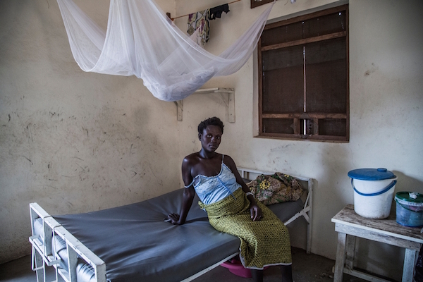 A pregnant woman waits to receive treatment at Gondama Health Center in Bo, Sierra Leone, in 2014. The Ebola outbreak forced MSF to close the GHC, as patients' and staff's safety could not be guarranteed. Recently MSF began supporting another maternal health hospital  in the region. Photo by Lam Yik Fei