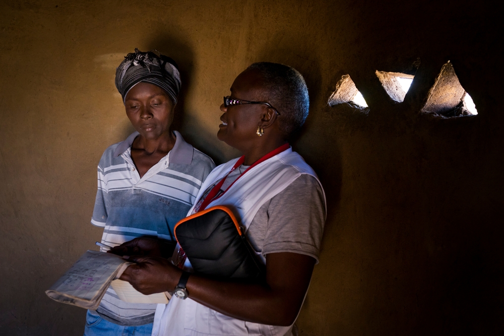 Faceme discusses her medical report with MSF nurse mentor Sister Tendai Chigurg. Photo by Melanie Wenger/COSMOS